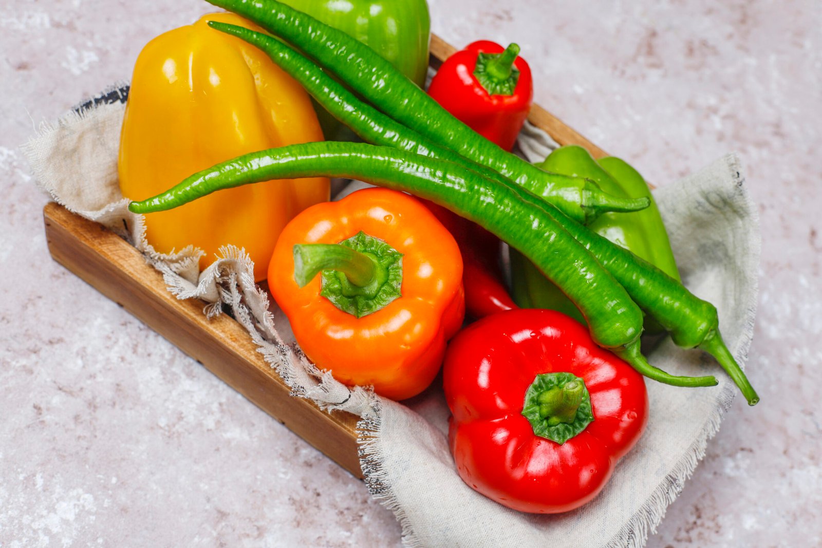 arrangement-colorful-fresh-assorted-bell-pepperson-concrete-surface-scaled.jpg